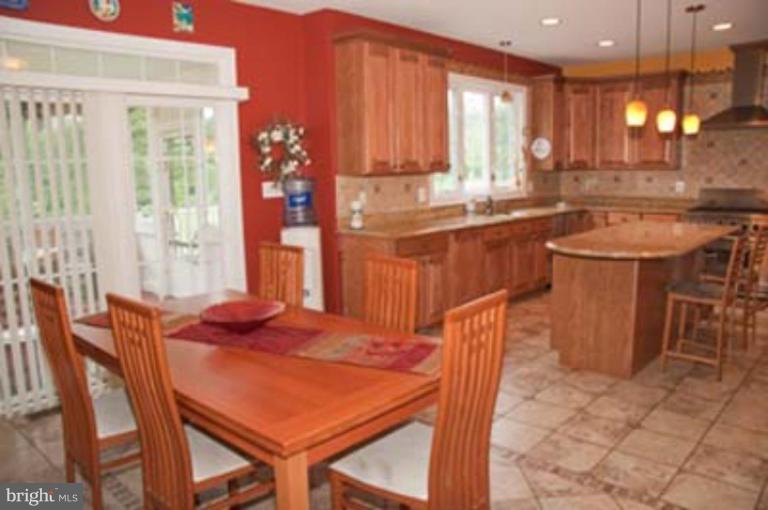 14616 Manor Road Phoenix, MD 21131 - Photo 12 of 30 a kitchen with a table chairs sink and cabinets