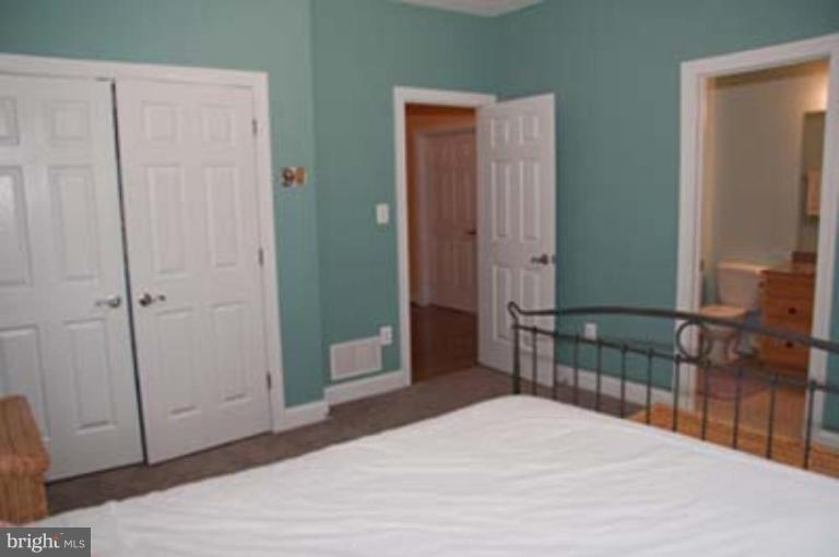 14616 Manor Road Phoenix, MD 21131 - Photo 19 of 30 a bedroom with a bed and a table