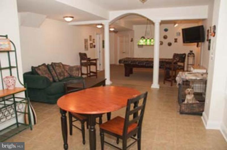 14616 Manor Road Phoenix, MD 21131 - Photo 25 of 30 a living room with furniture a flat screen tv and a table