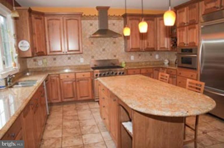 14616 Manor Road Phoenix, MD 21131 - Photo 10 of 30 a kitchen with a sink cabinets and stainless steel appliances