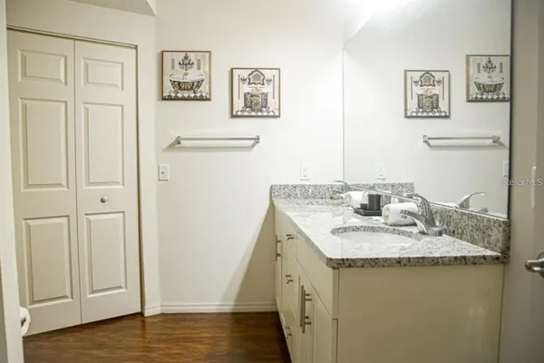 a bathroom with a granite countertop sink and a mirror