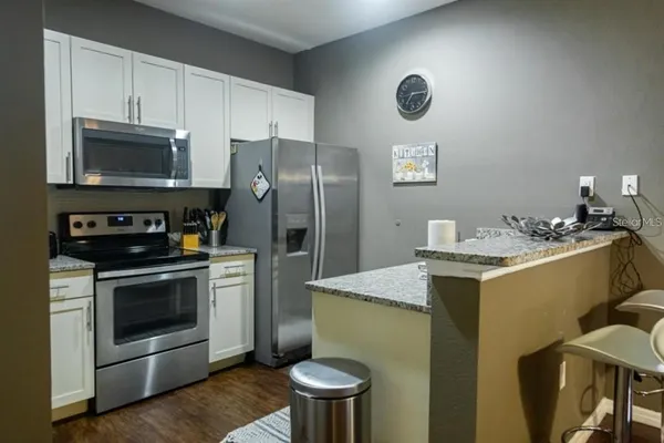 a kitchen with a stove sink and refrigerator