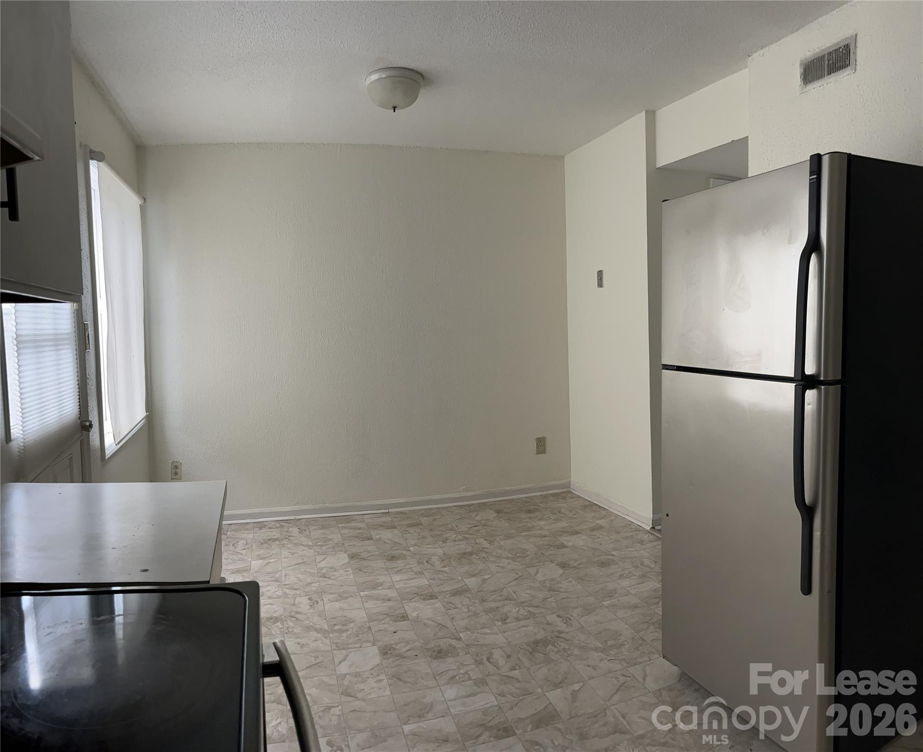 1911 Smoke Ridge Court, Unit 5 Charlotte, NC 28210 - Photo 6 of 16 a refrigerator freezer sitting in a kitchen