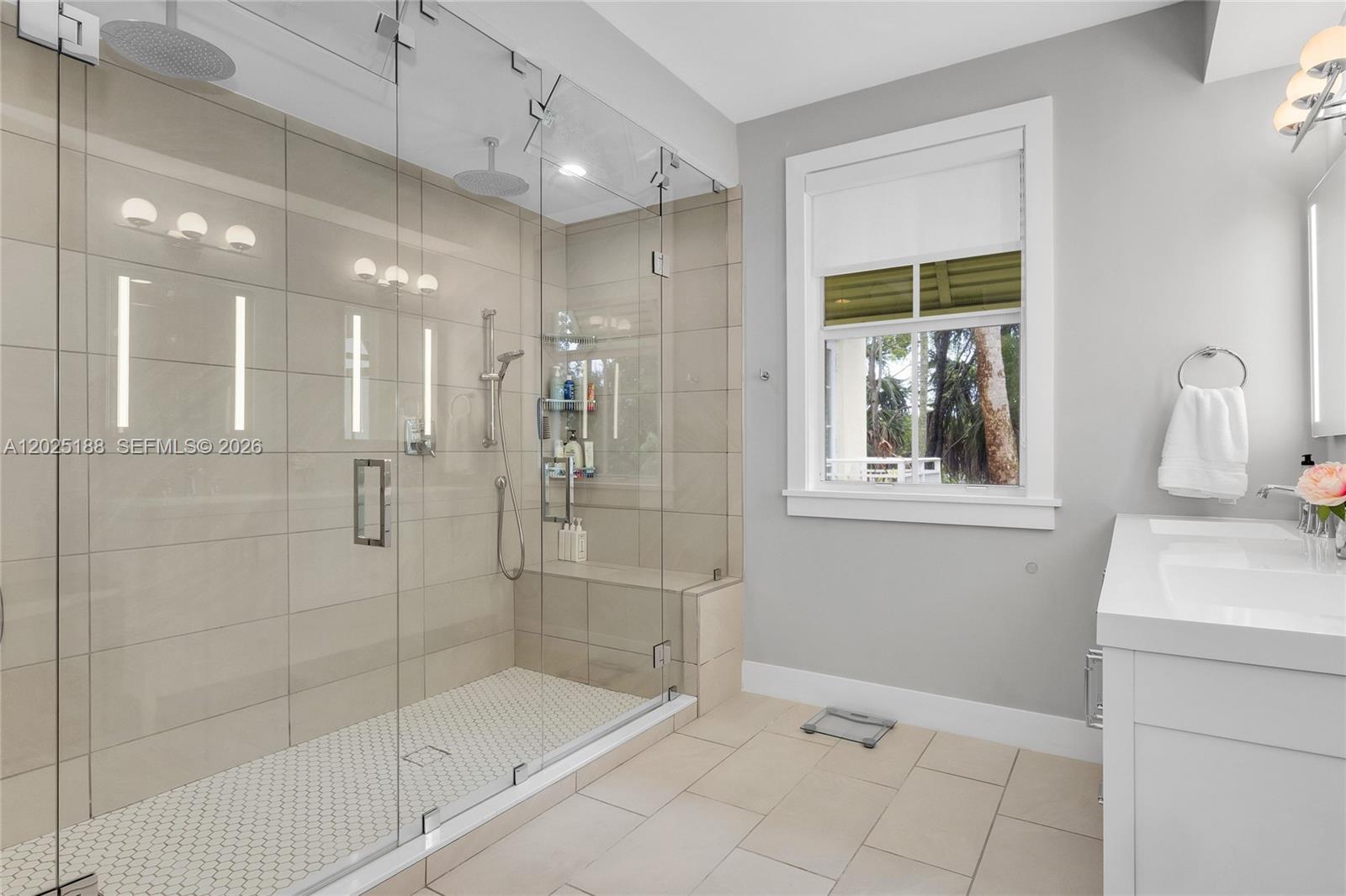 7620 Southwest 102nd Street, Unit 121 Pinecrest, FL 33156 - Photo 10 of 18 a bathroom with a shower sink and mirror