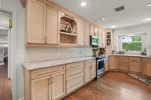 a kitchen with stainless steel appliances granite countertop a stove and a sink