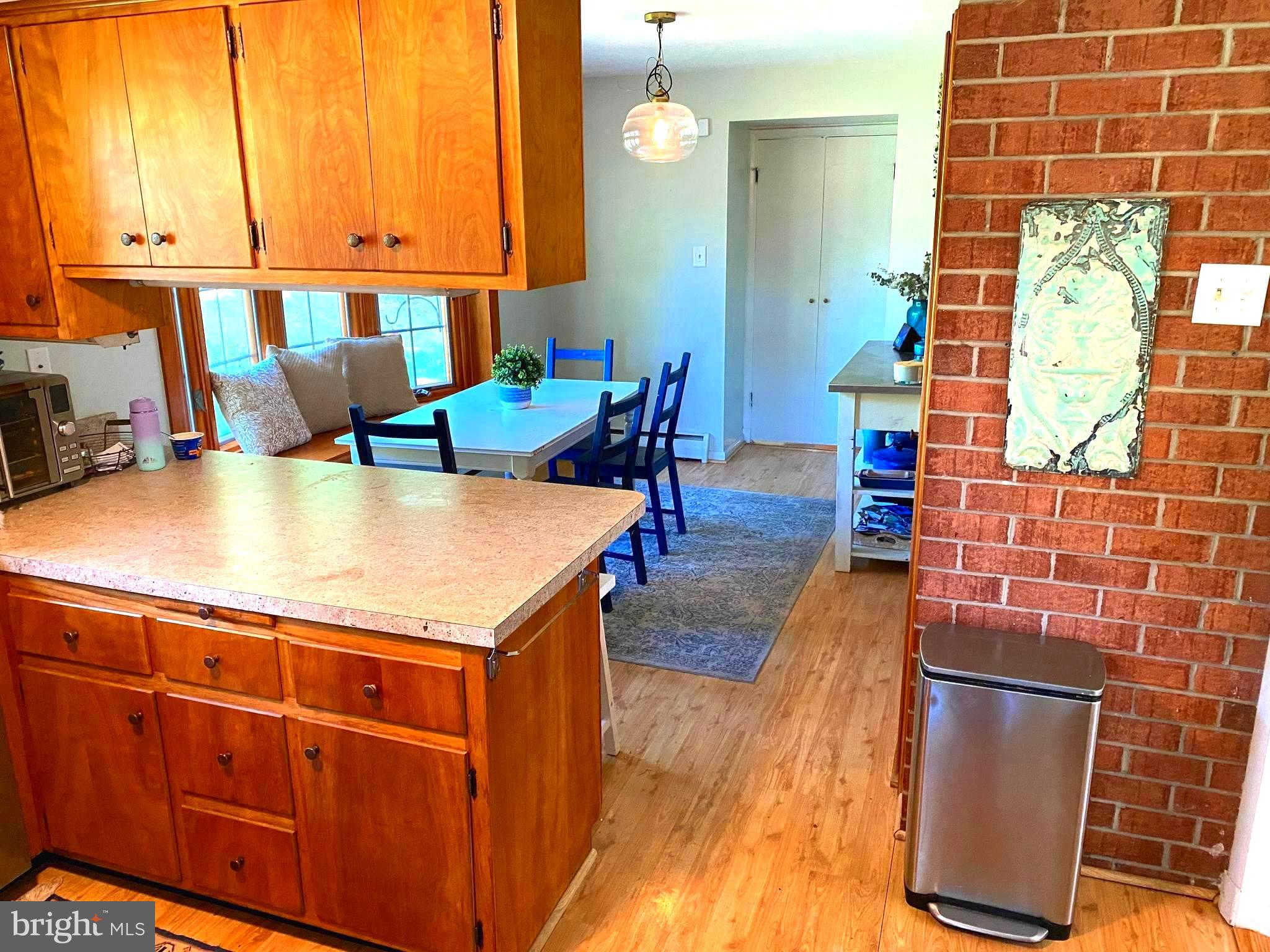 801 Stags Head Road Towson, MD 21286 - Photo 10 of 24 a kitchen with stainless steel appliances kitchen island granite countertop a table chairs and a refrigerator