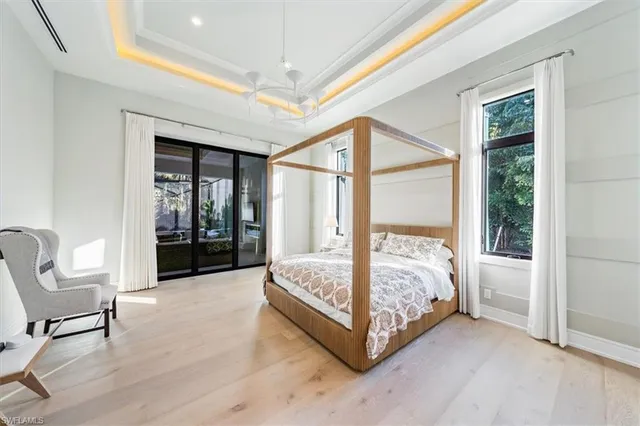 a bedroom with a bed chair and a window