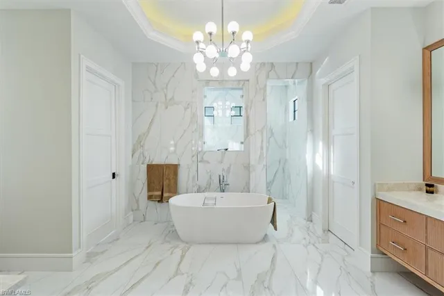 a spacious bathroom with a double vanity sink a mirror a window and a bathtub