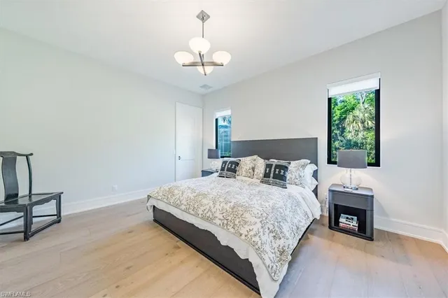 a bedroom with a bed and a chandelier