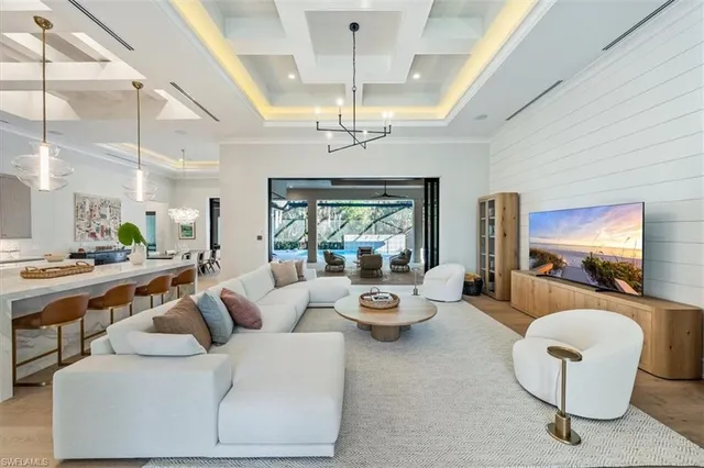 a living room with furniture and a chandelier