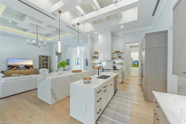 a large white kitchen with a large counter top cabinets and stainless steel appliances