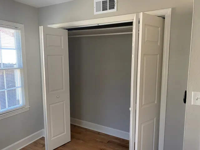 a view of closet area with wooden floor