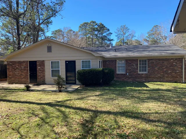a view of a house with swimming pool and a porch with furniture
