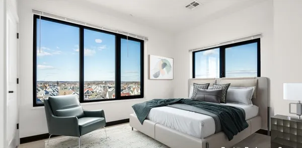 a bedroom with a large bed and a large window