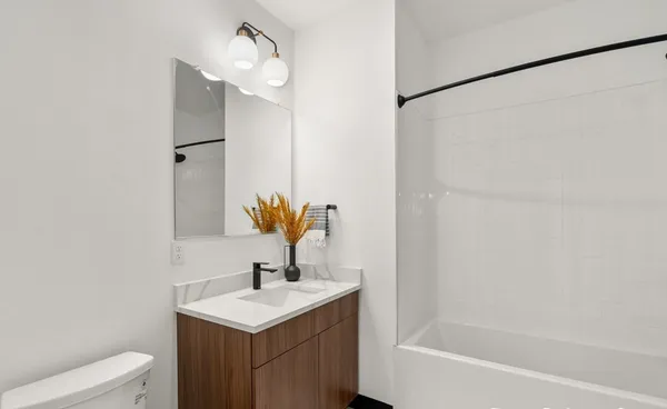 a bathroom with a sink toilet and shower