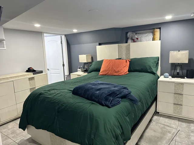 a bedroom with a bed and dresser