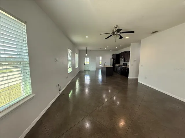 a view of a kitchen and a window in an empty room
