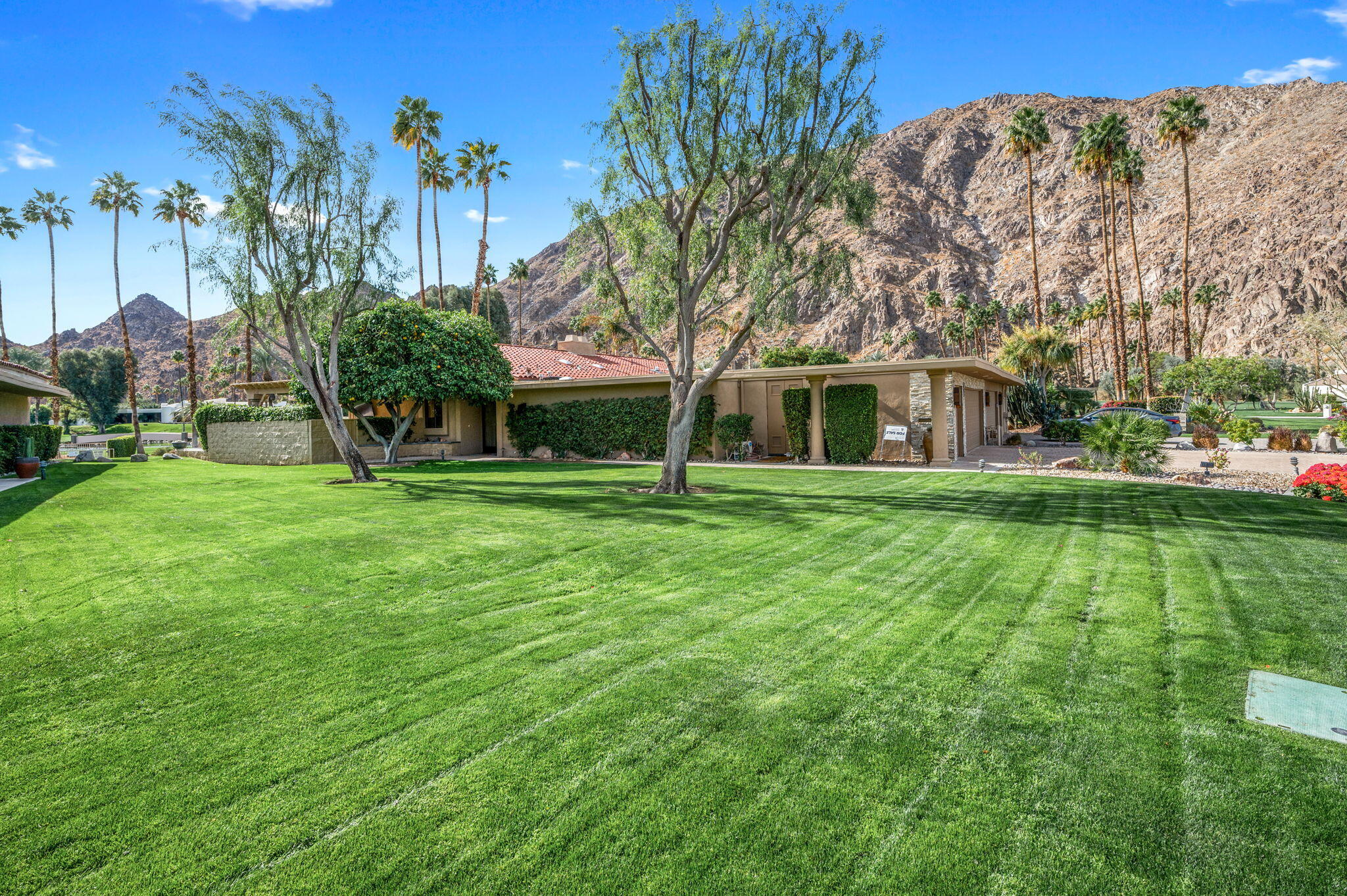 77675 Seminole Road Indian Wells, CA 92210 - Photo 8 of 40 a view of a house with a big yard and large trees