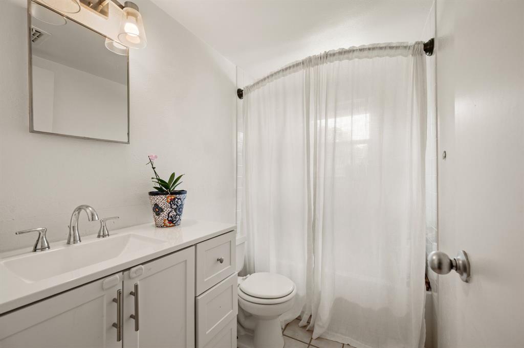 3900 Moseley Road Cross Roads, TX 76227 - Photo 16 of 36 Contemporary bathroom featuring a light-toned vanity with an integrated sink and chrome fixtures