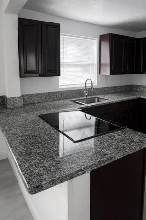 a kitchen with sink refrigerator and cabinets