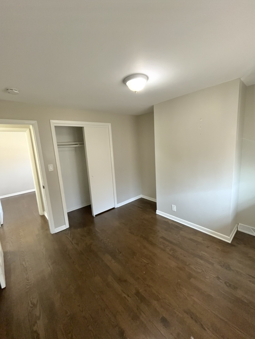 1308 191st Street Homewood, IL 60430 - Photo 11 of 15 an empty room with wooden floor and windows
