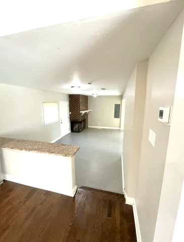 a kitchen with granite countertop a refrigerator and a sink