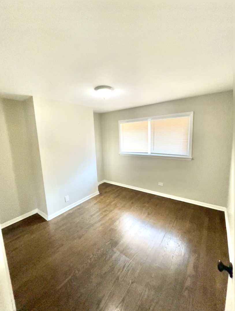 1308 191st Street Homewood, IL 60430 - Photo 10 of 15 an empty room with wooden floor and windows