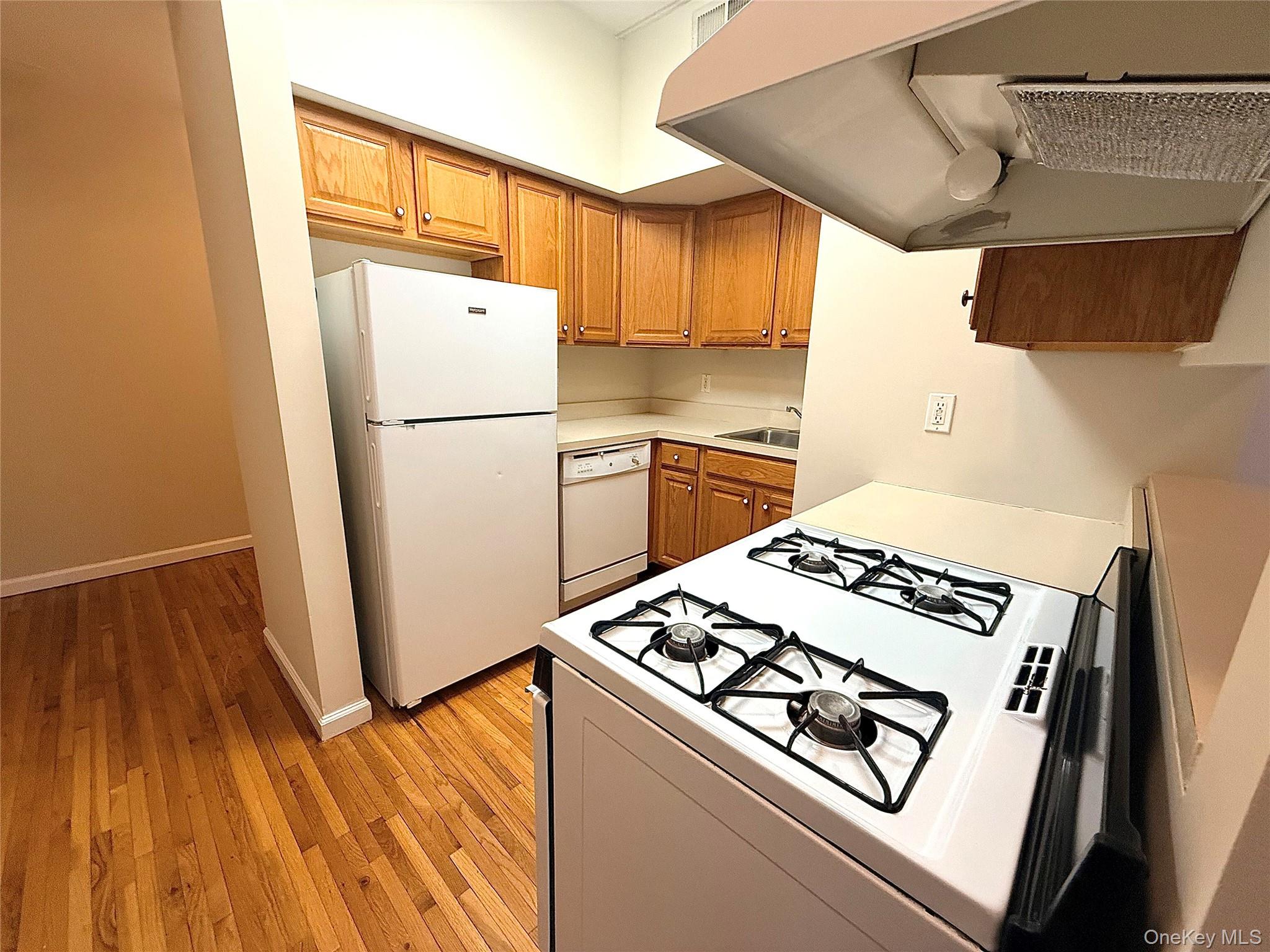70 Lime Kiln Road, Unit 1A Tuckahoe, NY 10707 - Photo 4 of 10 a kitchen with a stove a refrigerator and a wooden floor