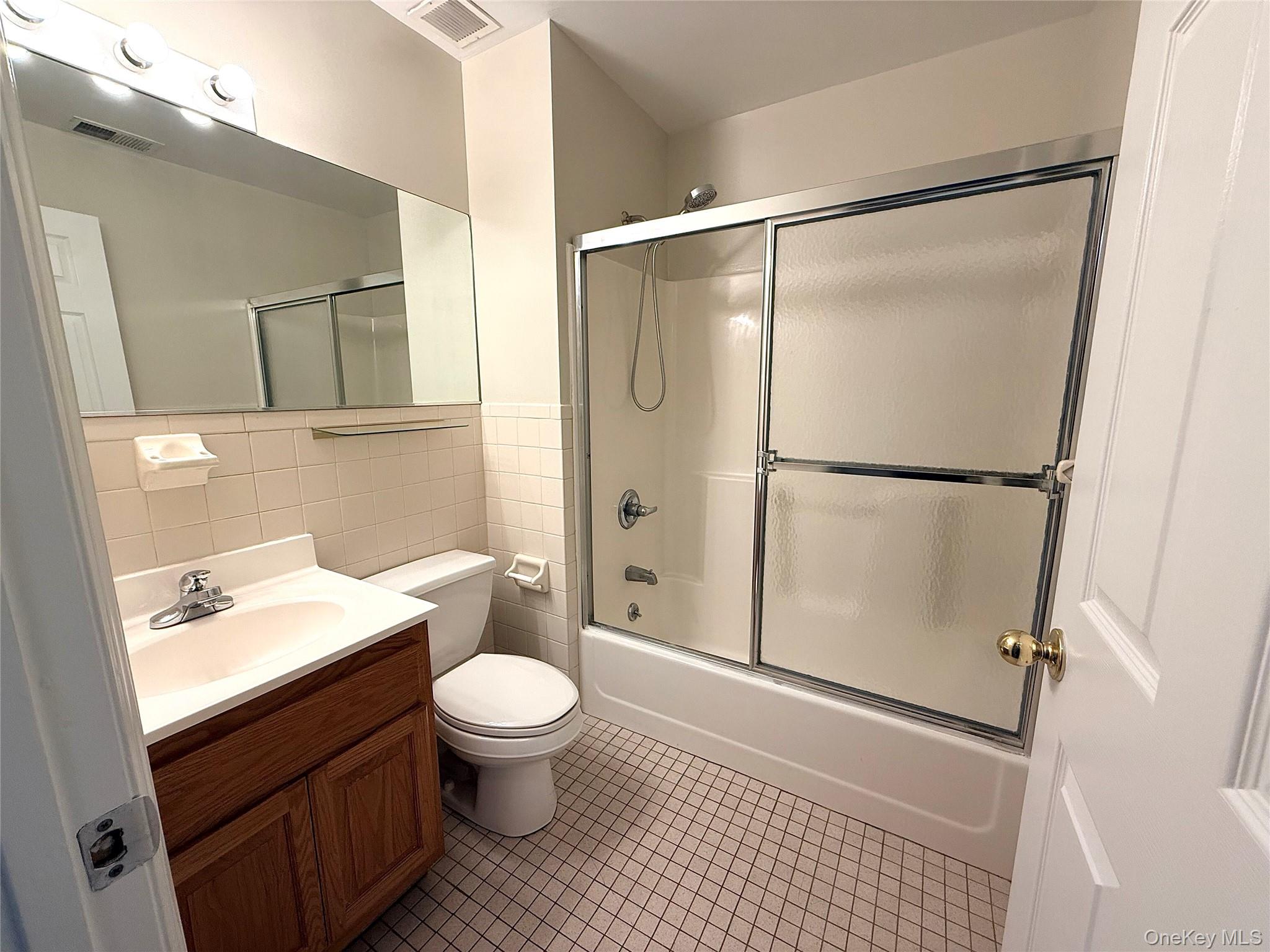 70 Lime Kiln Road, Unit 1A Tuckahoe, NY 10707 - Photo 8 of 10 a bathroom with a toilet a sink and a shower