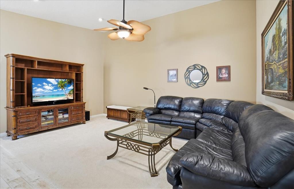 5546 Modena Place Sarasota, FL 34238 - Photo 17 of 67 a living room with furniture and a flat screen tv