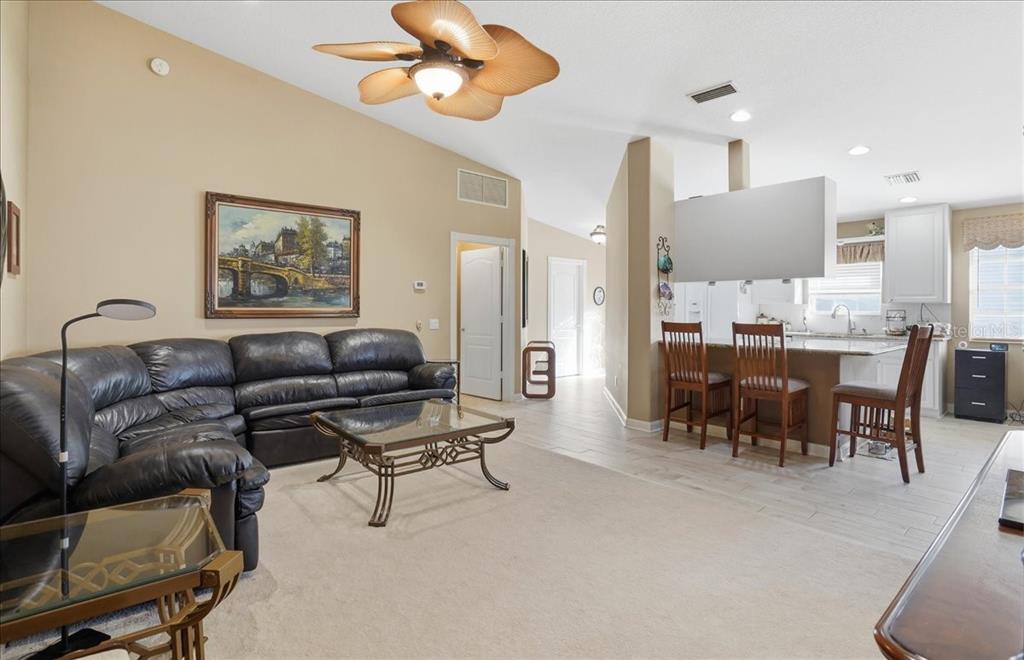 5546 Modena Place Sarasota, FL 34238 - Photo 18 of 67 a living room with furniture kitchen view and a chandelier