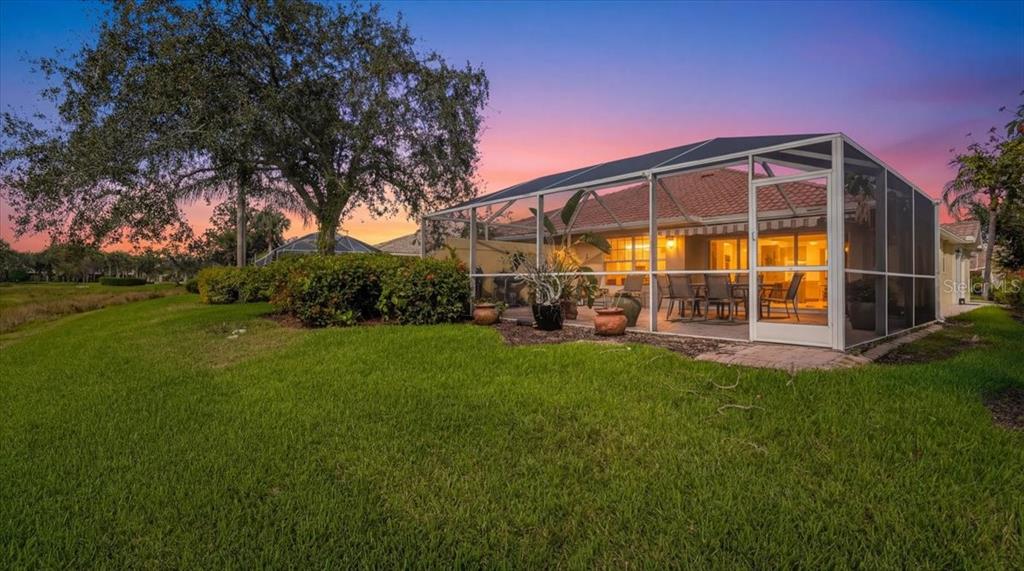 5546 Modena Place Sarasota, FL 34238 - Photo 2 of 67 a view of yard with swimming pool and green space