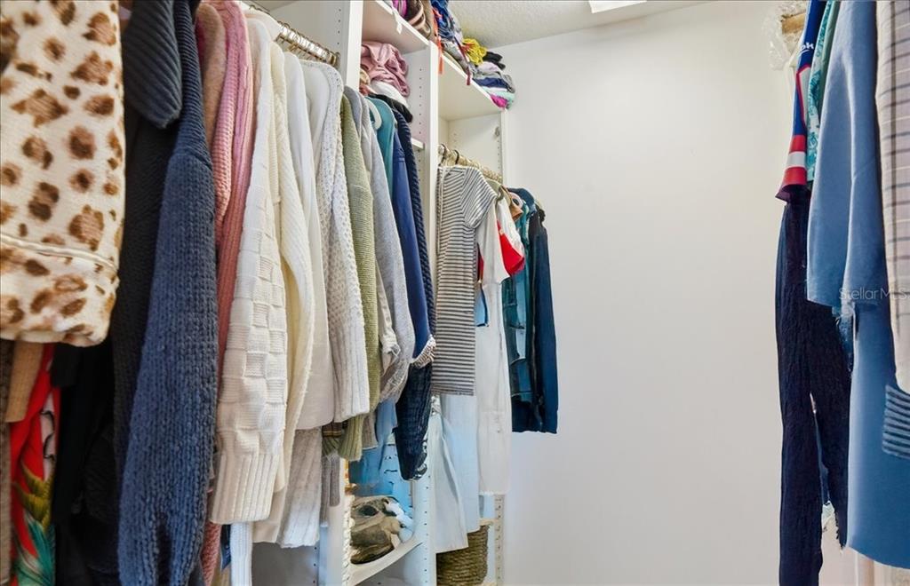 5546 Modena Place Sarasota, FL 34238 - Photo 24 of 67 a view of walk in closet with clothes and shoes
