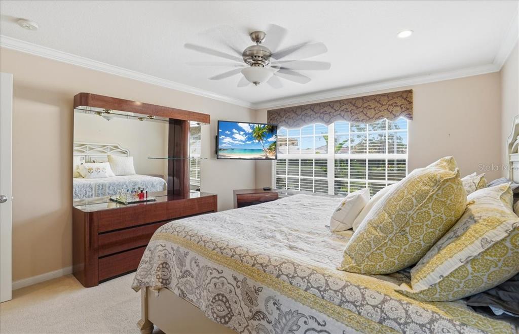 5546 Modena Place Sarasota, FL 34238 - Photo 26 of 67 a bed sitting in a bedroom next to a window