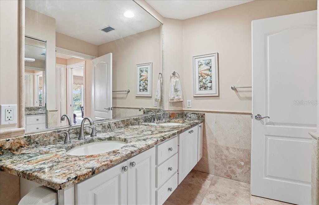 5546 Modena Place Sarasota, FL 34238 - Photo 28 of 67 a bathroom with a granite countertop sink and a mirror