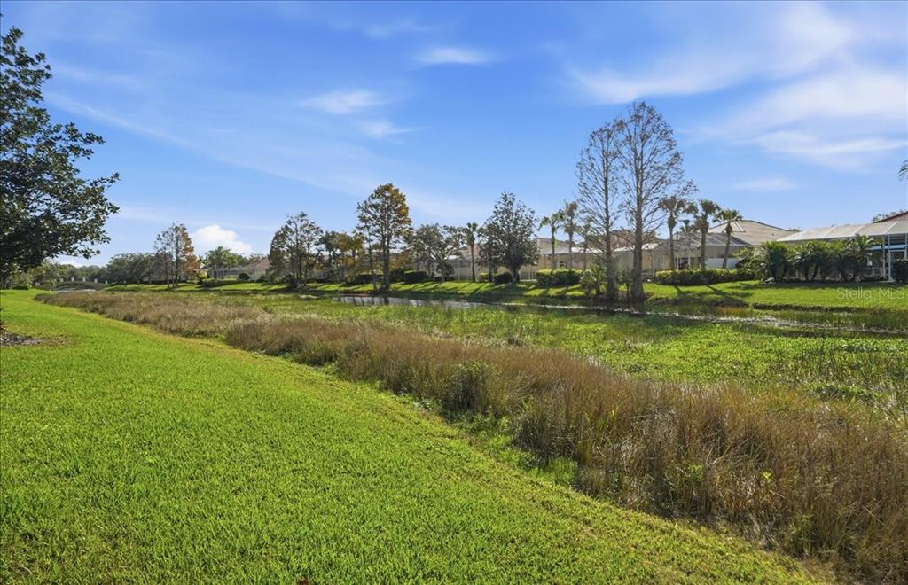 5546 Modena Place Sarasota, FL 34238 - Photo 34 of 67 a view of a lake with a big yard