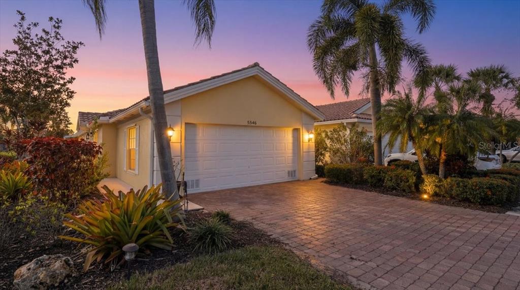 5546 Modena Place Sarasota, FL 34238 - Photo 40 of 67 a view of a house with a small yard and floor to ceiling window