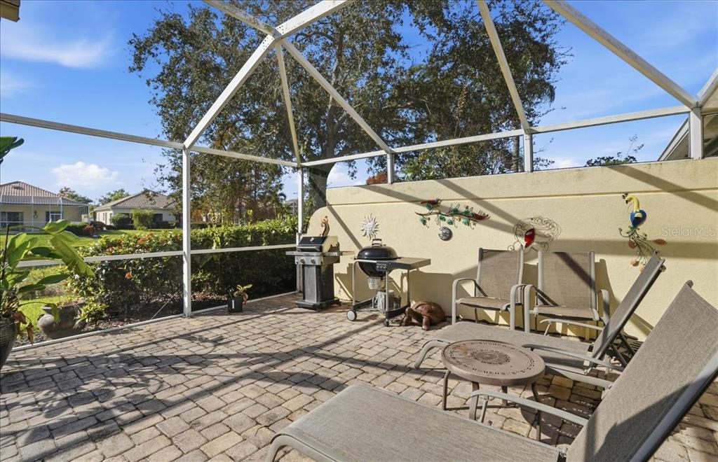 5546 Modena Place Sarasota, FL 34238 - Photo 48 of 67 a view of a patio with table and chairs with wooden floor and fence