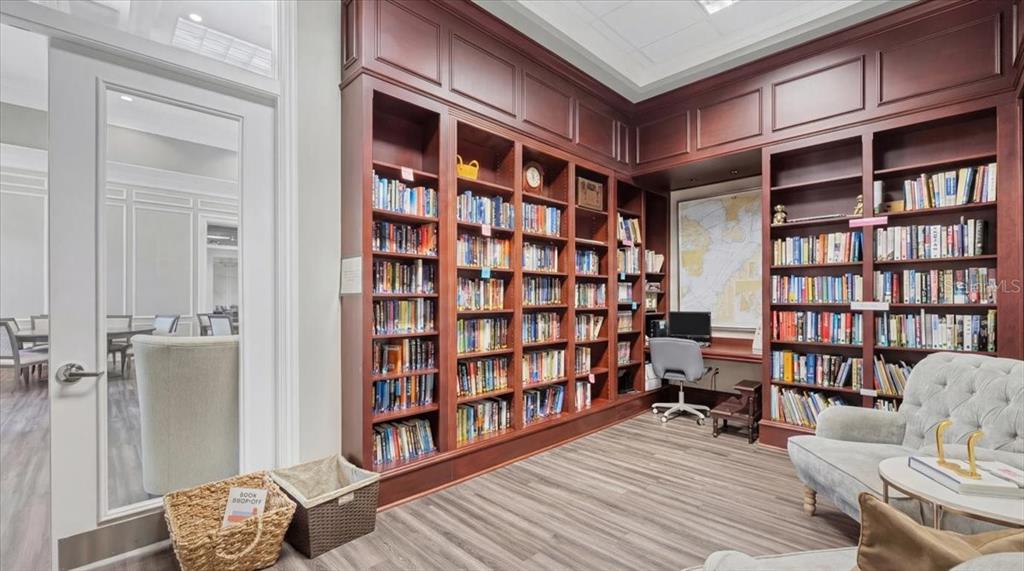 5546 Modena Place Sarasota, FL 34238 - Photo 59 of 67 a living room with furniture and a book shelf