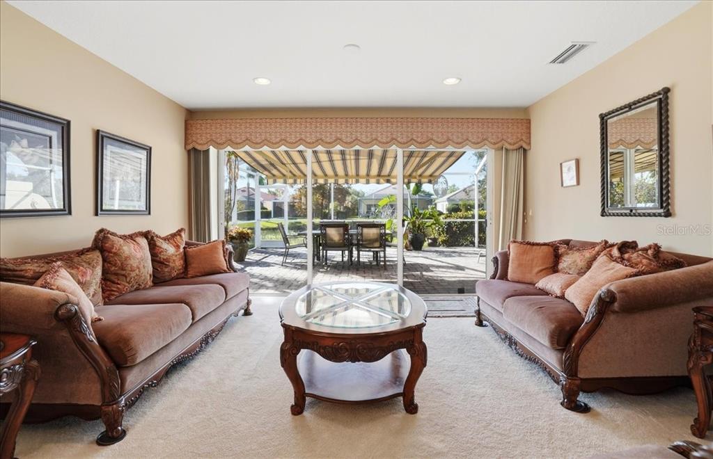 5546 Modena Place Sarasota, FL 34238 - Photo 9 of 67 a living room with furniture and a large window