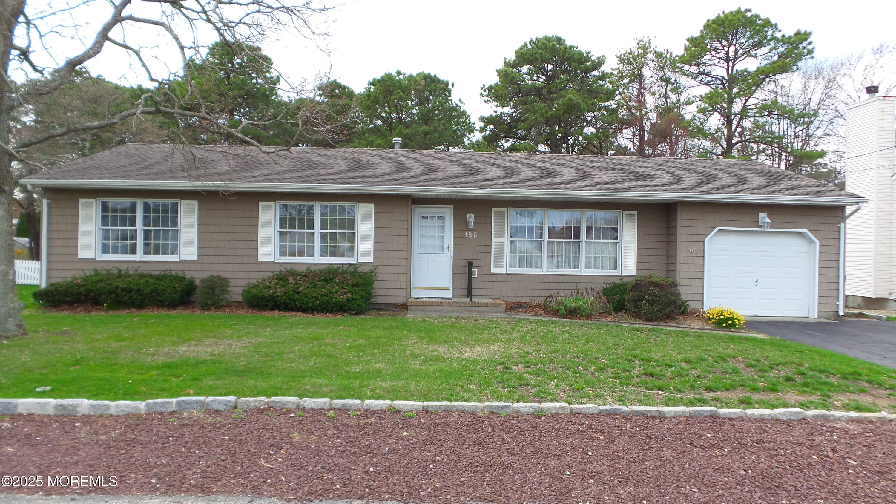 186 Cherry Quay Road Brick, NJ 08723 - Photo 1 of 20 a front view of a house with a yard and garage