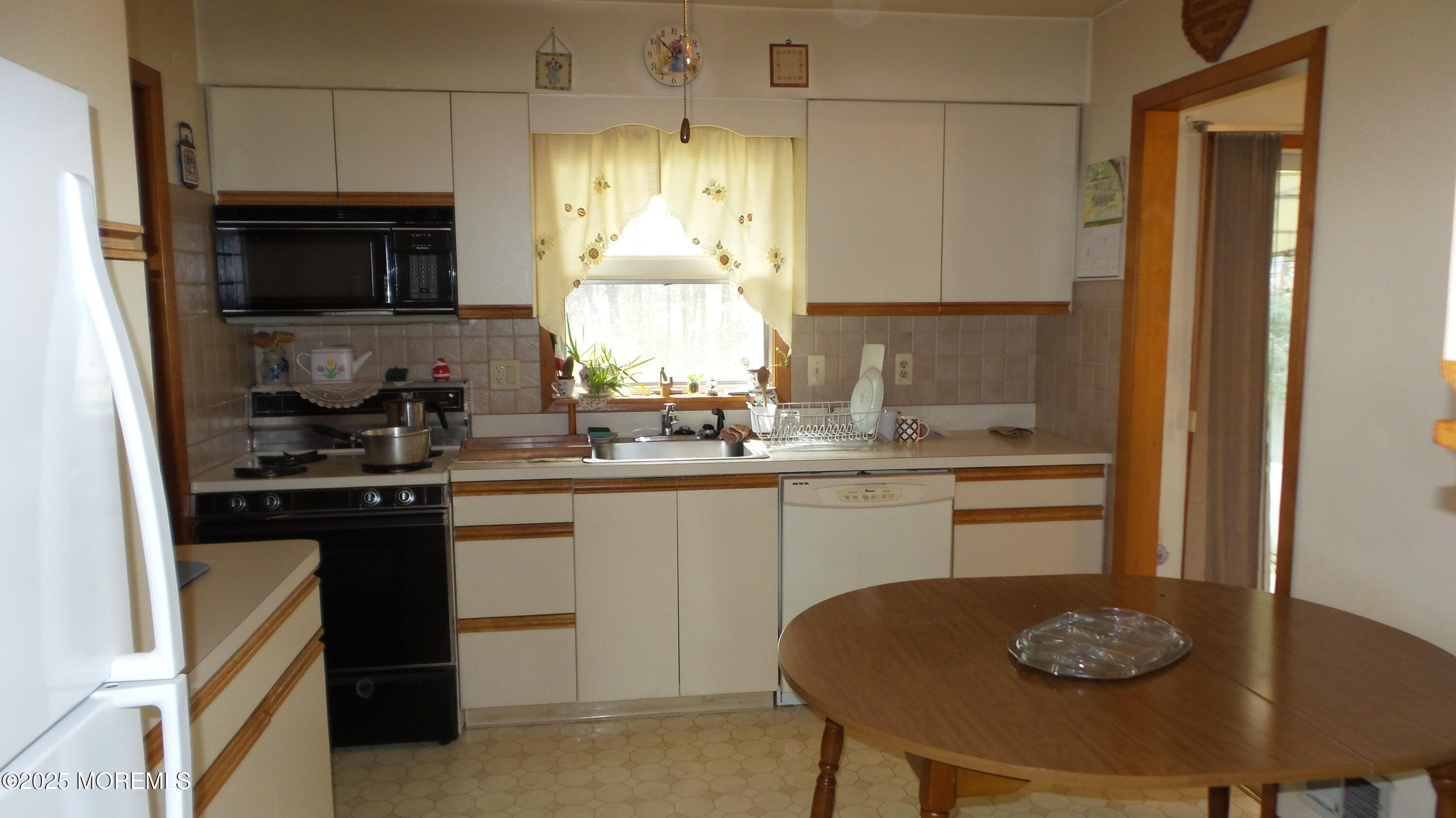 186 Cherry Quay Road Brick, NJ 08723 - Photo 5 of 20 a kitchen with a sink a stove and chairs