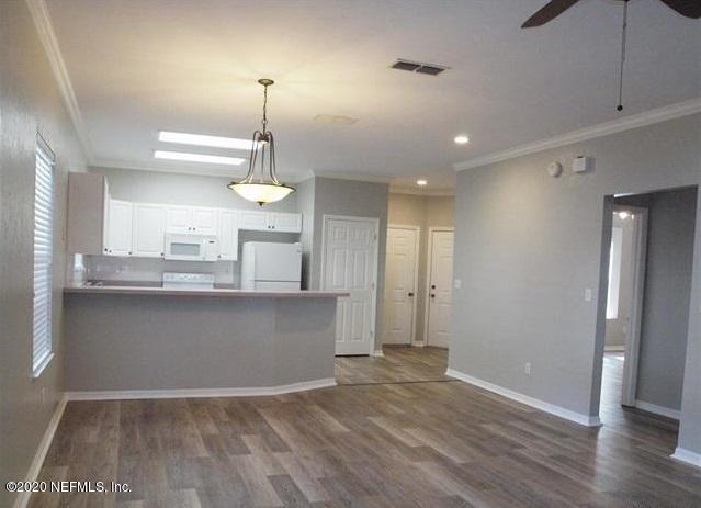4706 Northwest 75th Road Gainesville, FL 32653 - Photo 3 of 19 a view of a kitchen with a sink and wooden floor