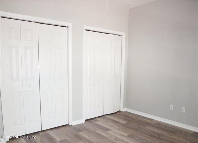 4706 Northwest 75th Road Gainesville, FL 32653 - Photo 8 of 19 a view of an empty room with wooden floor