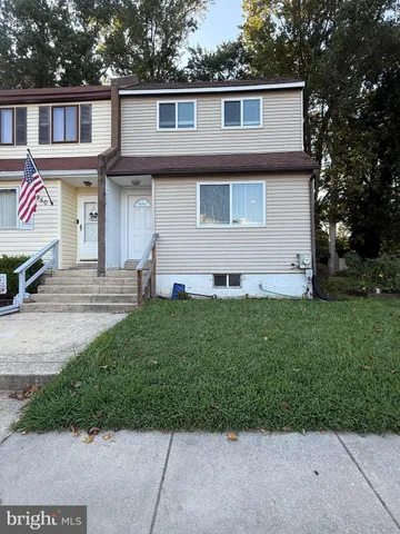 a front view of a house with a garden and yard