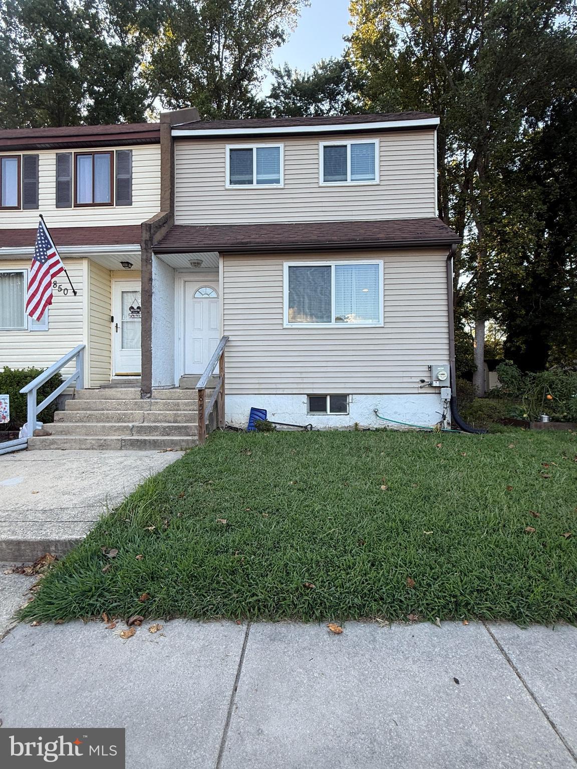 a front view of a house with a garden and yard