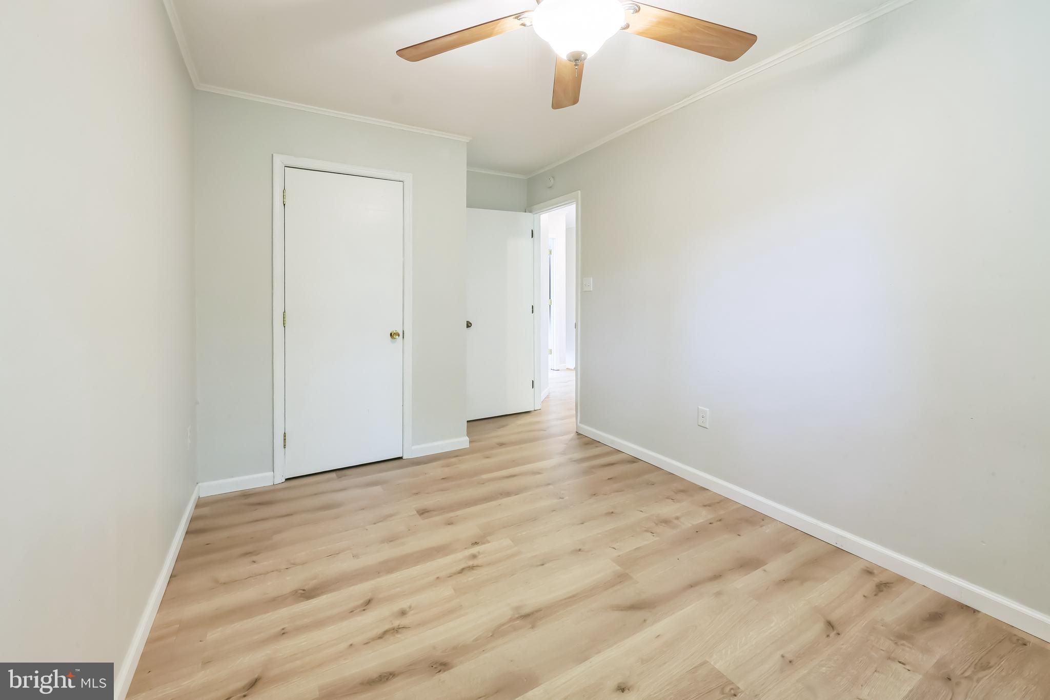 852 Hasting Court Newark, DE 19702 - Photo 23 of 29 en empty room with wooden floor and fan
