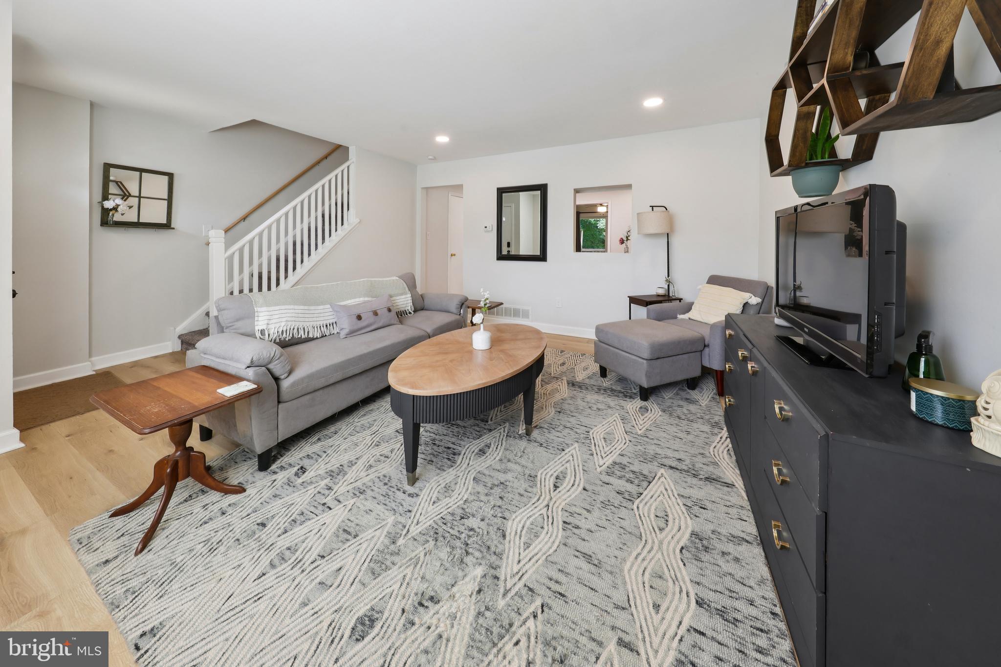 852 Hasting Court Newark, DE 19702 - Photo 4 of 29 a living room with furniture a rug and a flat screen tv