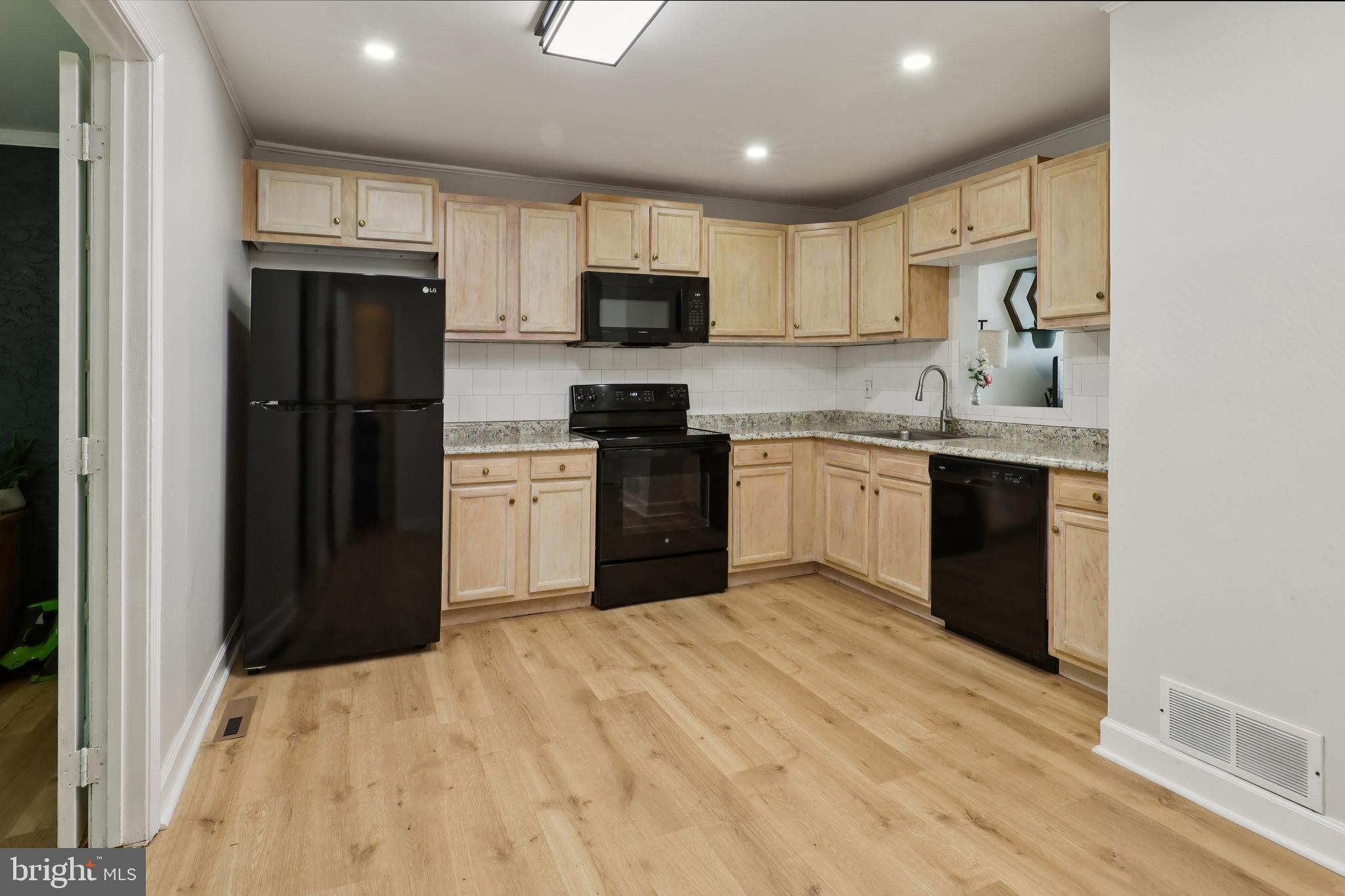 852 Hasting Court Newark, DE 19702 - Photo 7 of 29 a kitchen with stainless steel appliances granite countertop a refrigerator stove top oven and sink
