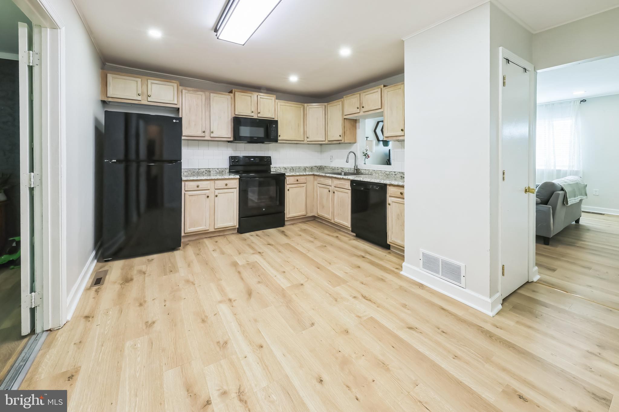 852 Hasting Court Newark, DE 19702 - Photo 9 of 29 a kitchen with granite countertop a refrigerator stove top oven and cabinets